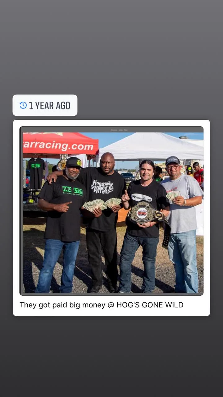 A saved Hogs Gone Wild winner photo showing Scott with a championship belt and fellow racers
