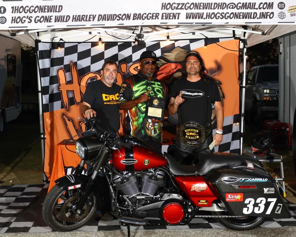 Scott holding the GRC Street championship belt behind the number 337 race bike