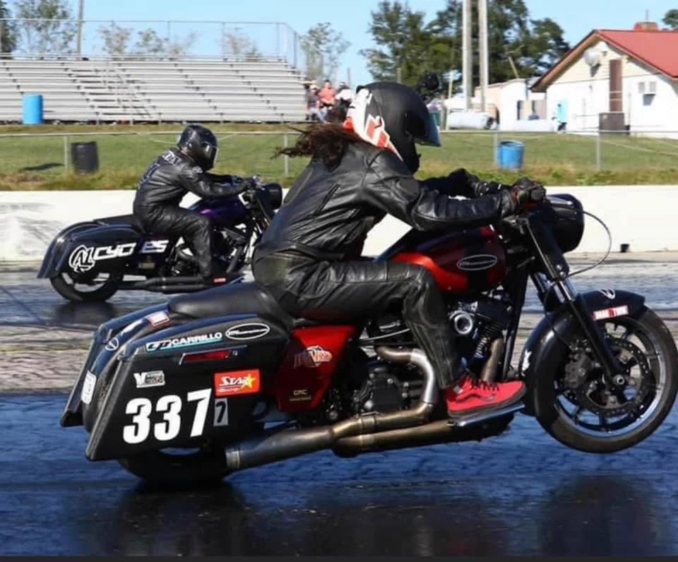 Scott racing the red number 337 bagger alongside Joe Gladden at the drag strip